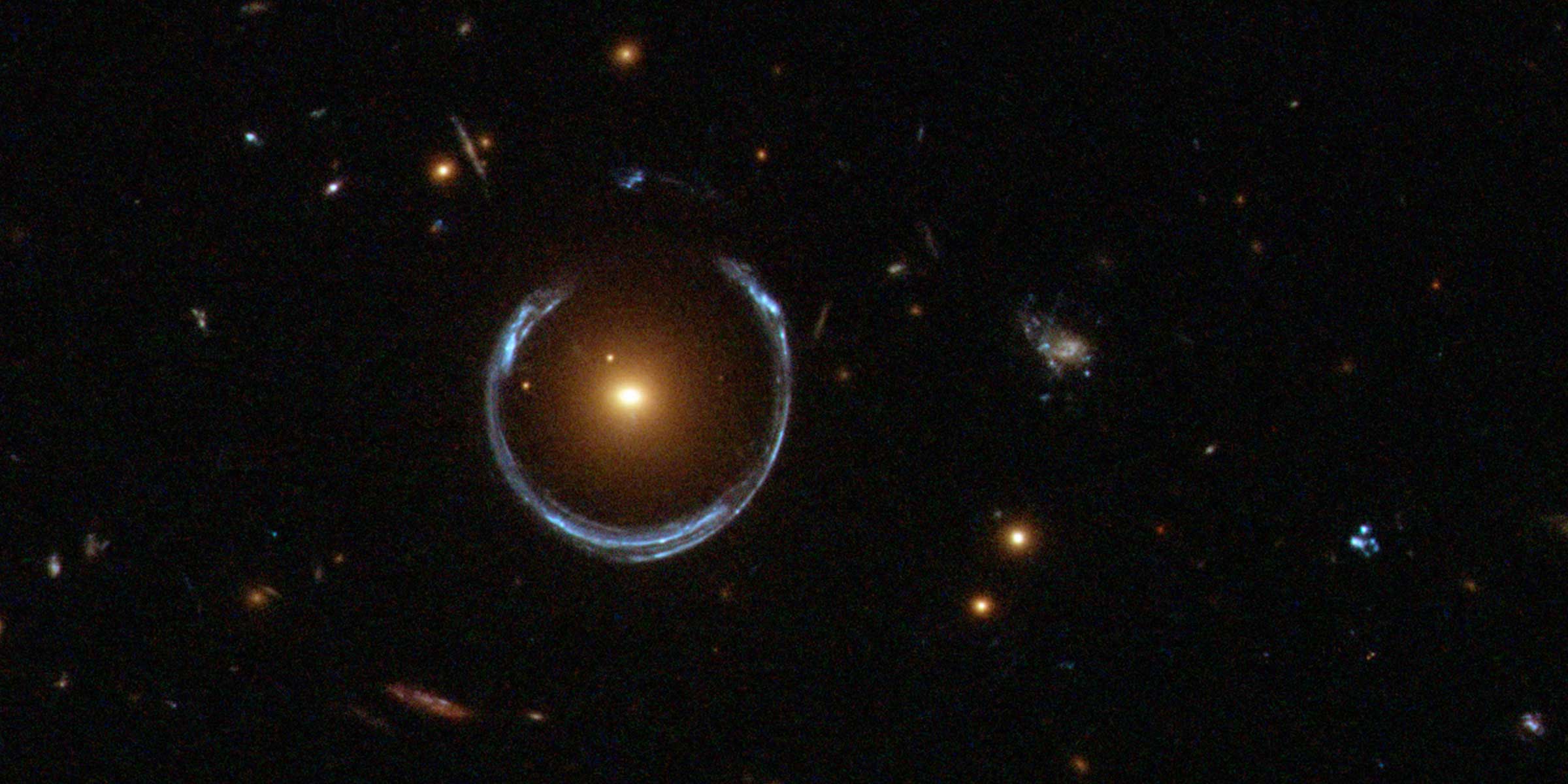 The gravity of a luminous red galaxy (LRG) has gravitationally distorted the lig.jpg